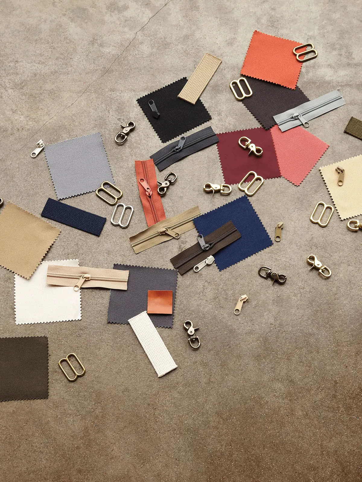Fabric swatches and hardware selected for custom merchandise production