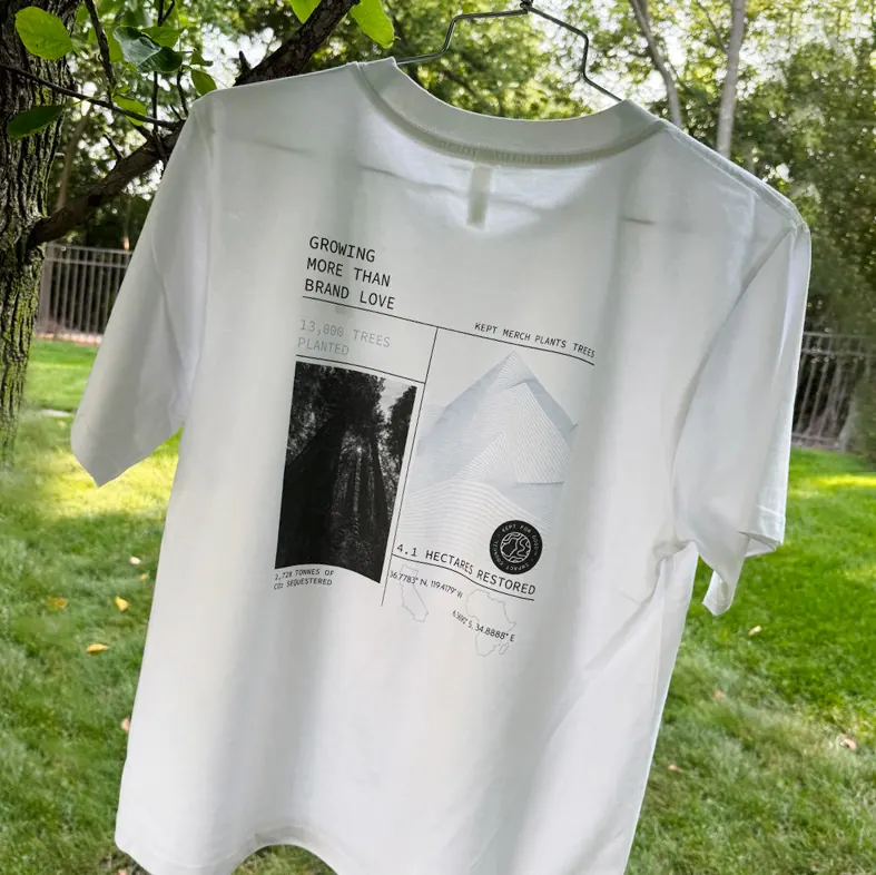 Kept tee printed with tree-planting impact stats, hung outdoors as a gift example