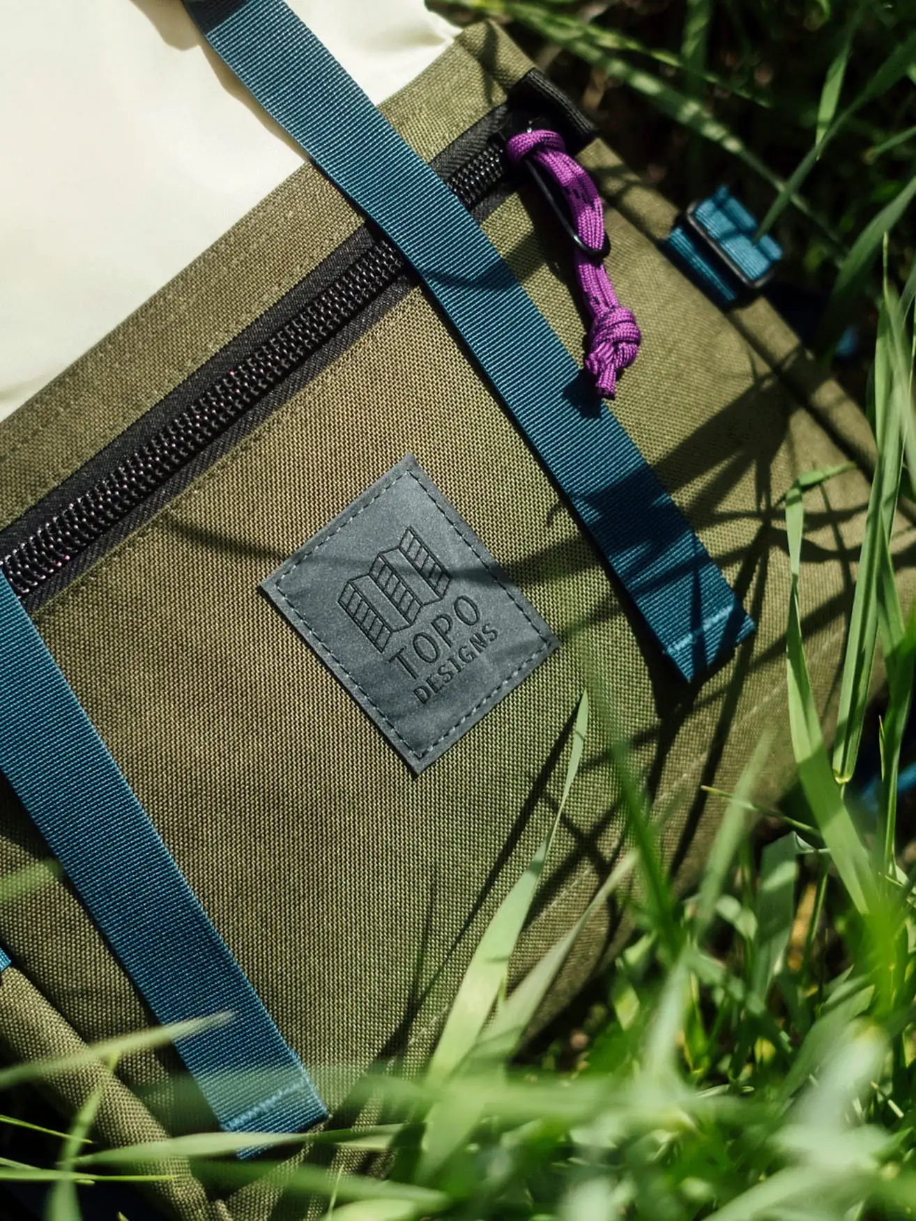 Topo backpack in grass. 